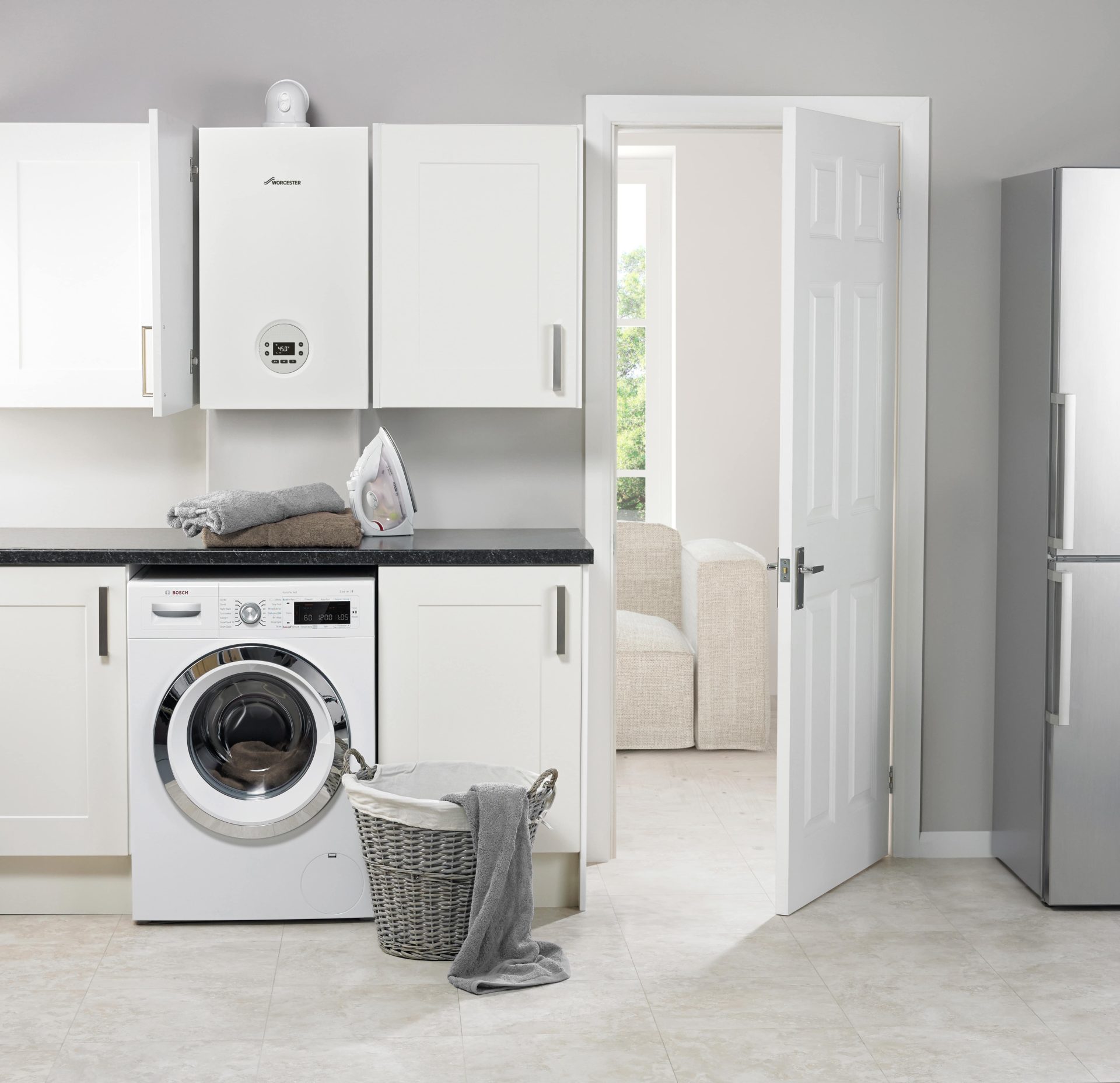 Worcester Bosch boiler installed in a utility room above a washing machine
